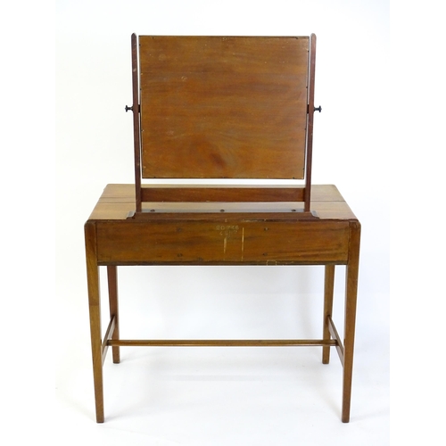 1430 - A mid 20thC Art Deco walnut dressing table, with a squared mirror above three short drawers with bra... 