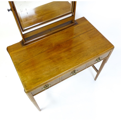 1430 - A mid 20thC Art Deco walnut dressing table, with a squared mirror above three short drawers with bra... 