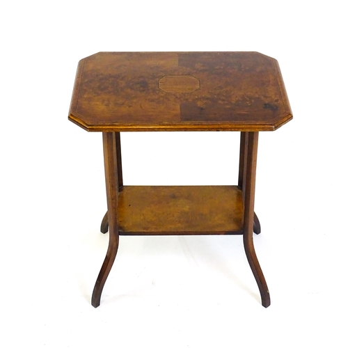 1431 - An early 20thC burr walnut occasional table with a canted table top above a rectangular under tier a... 