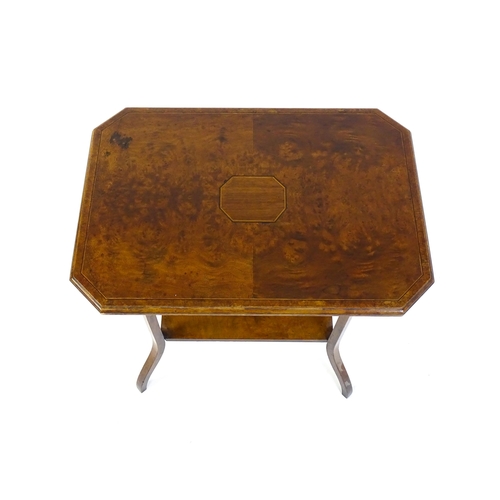 1431 - An early 20thC burr walnut occasional table with a canted table top above a rectangular under tier a... 