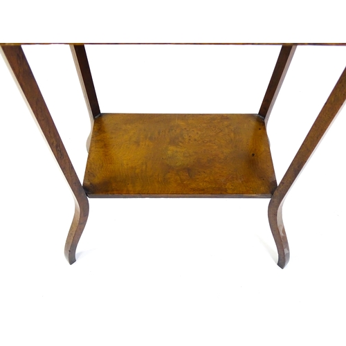 1431 - An early 20thC burr walnut occasional table with a canted table top above a rectangular under tier a... 