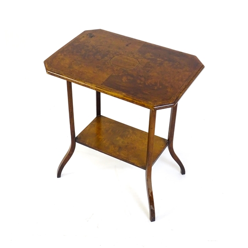 1431 - An early 20thC burr walnut occasional table with a canted table top above a rectangular under tier a... 