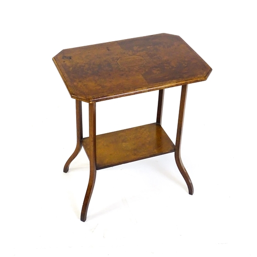 1431 - An early 20thC burr walnut occasional table with a canted table top above a rectangular under tier a... 