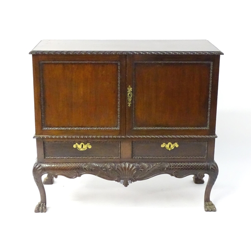 1433 - A 19thC Chippendale style cabinet, with a gadrooned rectangular top above two moulded and panelled d... 