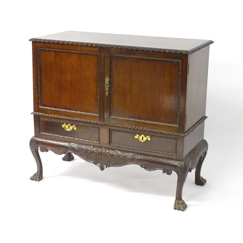 1433 - A 19thC Chippendale style cabinet, with a gadrooned rectangular top above two moulded and panelled d... 