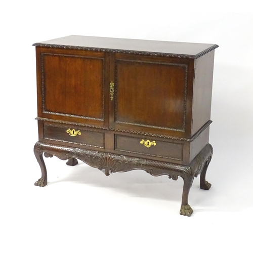 1433 - A 19thC Chippendale style cabinet, with a gadrooned rectangular top above two moulded and panelled d... 