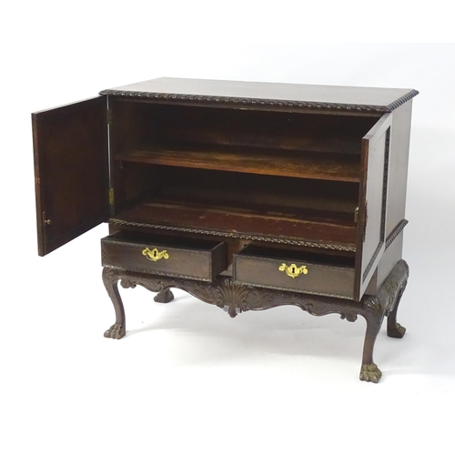 1433 - A 19thC Chippendale style cabinet, with a gadrooned rectangular top above two moulded and panelled d... 