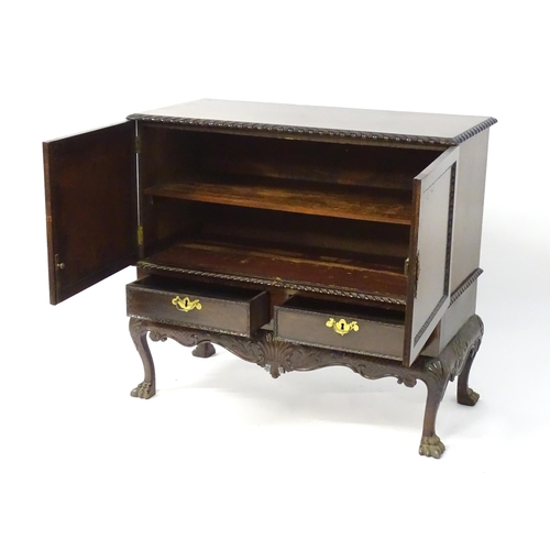 1433 - A 19thC Chippendale style cabinet, with a gadrooned rectangular top above two moulded and panelled d... 