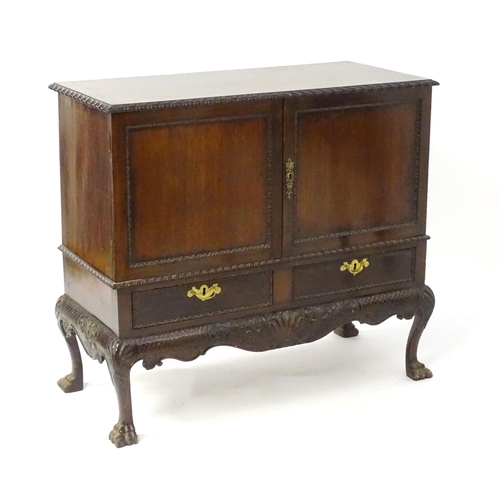 1433 - A 19thC Chippendale style cabinet, with a gadrooned rectangular top above two moulded and panelled d... 