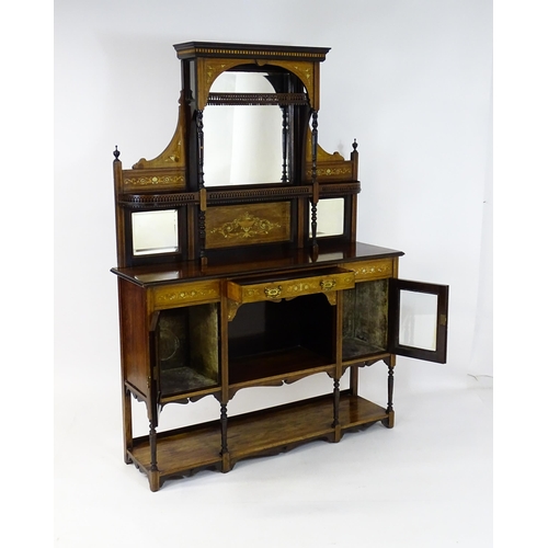 1434 - A late 19thC / early 20thC rosewood sideboard with a mirrored back, pierced galleries, turned suppor... 