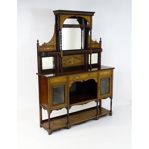 1434 - A late 19thC / early 20thC rosewood sideboard with a mirrored back, pierced galleries, turned suppor... 