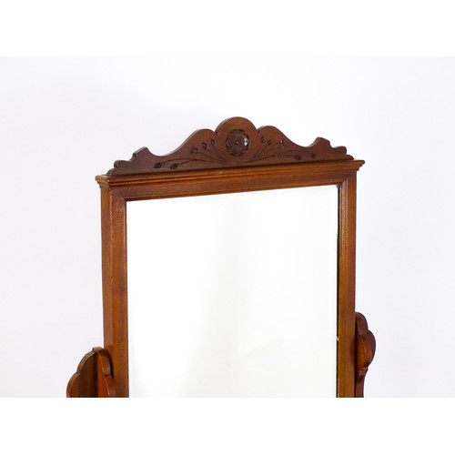 1435 - An Aesthetic movement mahogany dressing table with carved floral detailing, two short drawers above ... 