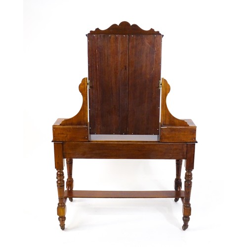 1435 - An Aesthetic movement mahogany dressing table with carved floral detailing, two short drawers above ... 