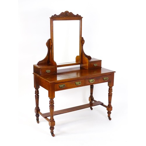 1435 - An Aesthetic movement mahogany dressing table with carved floral detailing, two short drawers above ... 