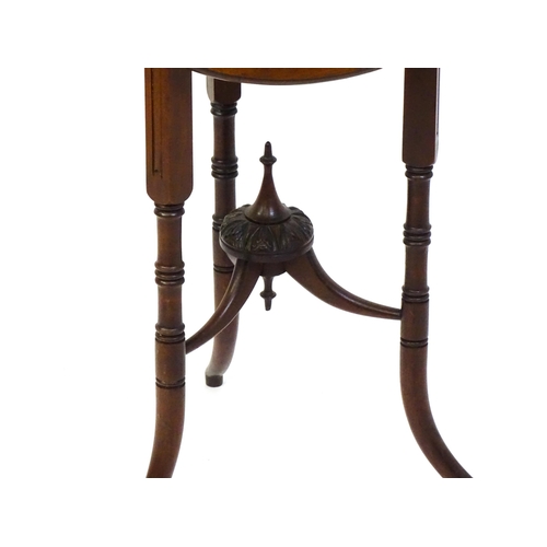 1436 - A mid / late 19thC mahogany occasional table with three drop leaves, the table bearing a label H. Go... 