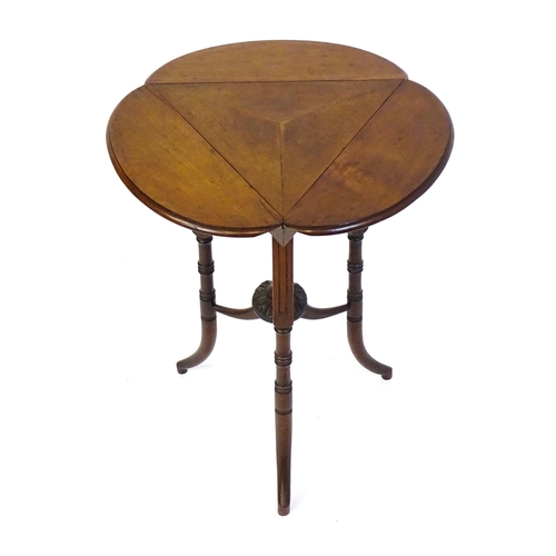 1436 - A mid / late 19thC mahogany occasional table with three drop leaves, the table bearing a label H. Go... 