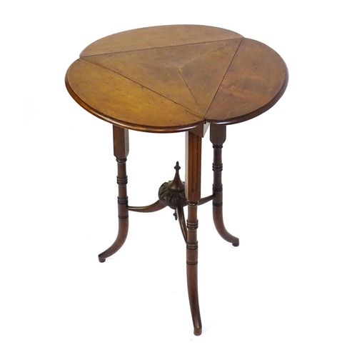 1436 - A mid / late 19thC mahogany occasional table with three drop leaves, the table bearing a label H. Go... 