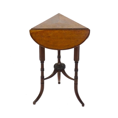 1436 - A mid / late 19thC mahogany occasional table with three drop leaves, the table bearing a label H. Go... 