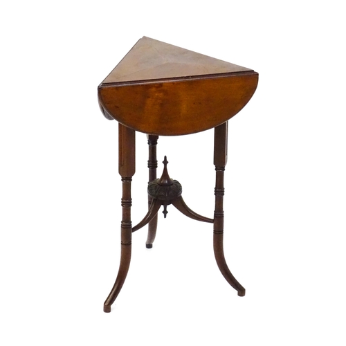 1436 - A mid / late 19thC mahogany occasional table with three drop leaves, the table bearing a label H. Go... 