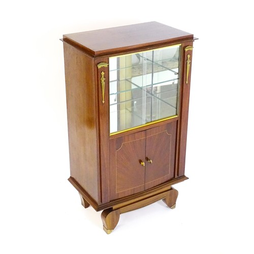 1437 - A mid 20thC continental cabinet with a palissandre veneered frame, brass mounts, internal mirrors an... 