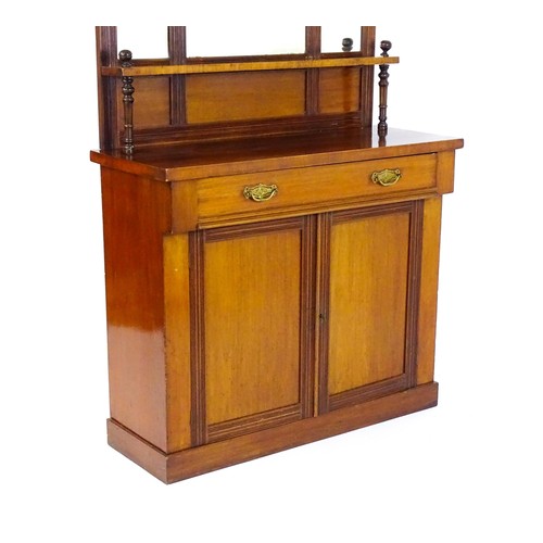 1438 - An Aesthetic movement mahogany chiffonier with a mirrored back, galleries of turned finials and reed... 