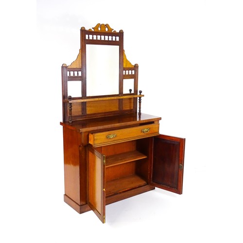 1438 - An Aesthetic movement mahogany chiffonier with a mirrored back, galleries of turned finials and reed... 