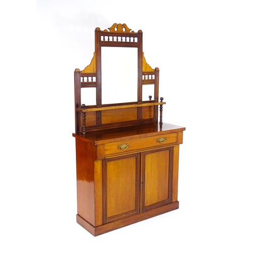 1438 - An Aesthetic movement mahogany chiffonier with a mirrored back, galleries of turned finials and reed... 