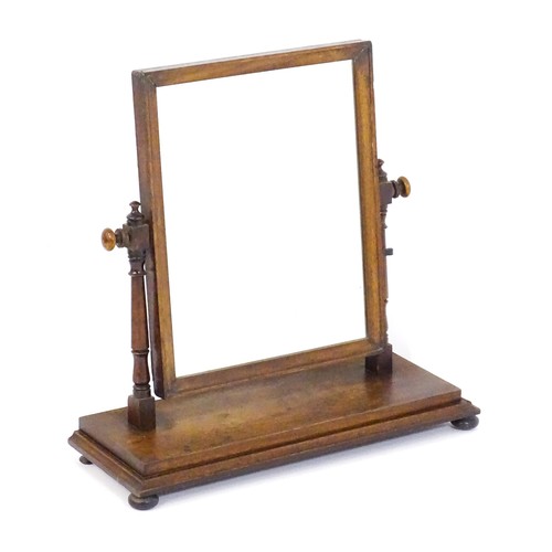 1439 - A Victorian mahogany mirror, the rectangular surround supported by turned uprights to either side su... 