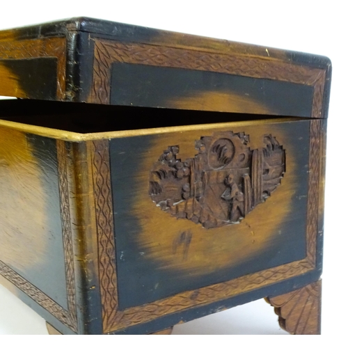 1441 - An early 20thC oriental camphor wood trunk with sides, lid and front, depicting figures within a lan... 