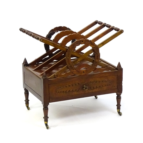 1442 - A mid 19thC mahogany Canterbury with three x-formed sections with laurel wreath style centres above ... 