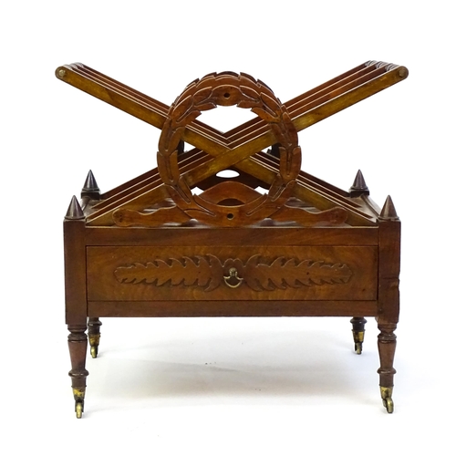 1442 - A mid 19thC mahogany Canterbury with three x-formed sections with laurel wreath style centres above ... 