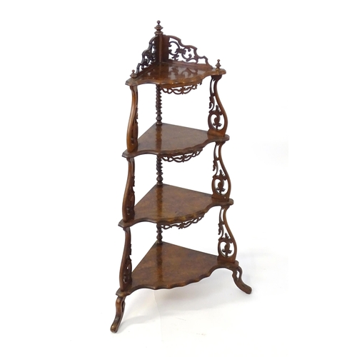 1446 - A 19thC burr walnut corner etagere, having pierced carved decoration to each tier and the supports, ... 