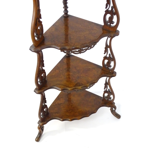 1446 - A 19thC burr walnut corner etagere, having pierced carved decoration to each tier and the supports, ... 