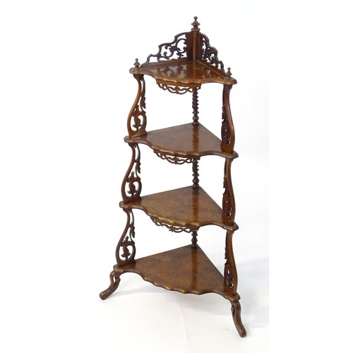 1446 - A 19thC burr walnut corner etagere, having pierced carved decoration to each tier and the supports, ... 