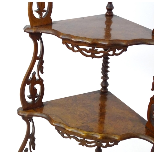 1446 - A 19thC burr walnut corner etagere, having pierced carved decoration to each tier and the supports, ... 