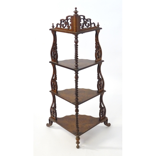 1446 - A 19thC burr walnut corner etagere, having pierced carved decoration to each tier and the supports, ... 