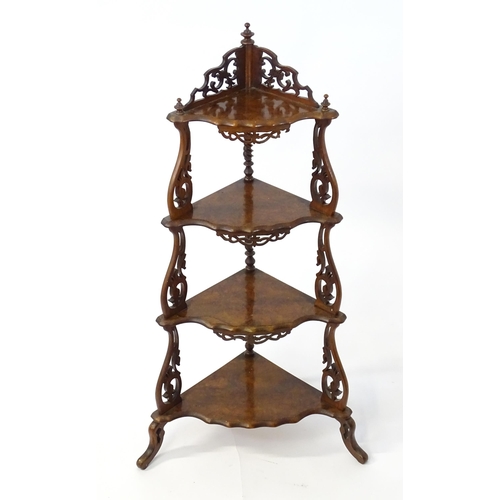 1446 - A 19thC burr walnut corner etagere, having pierced carved decoration to each tier and the supports, ... 