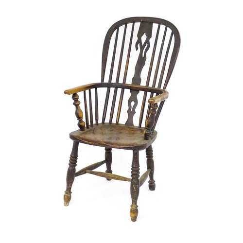 1447 - A mid 19thC ash and elm double bow back Windsor armchair, having a central pierced back splat above ... 