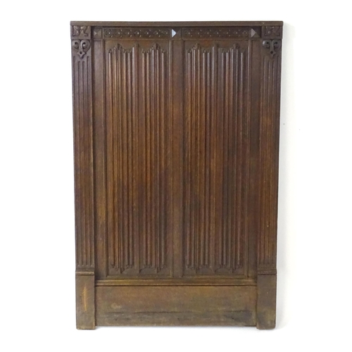 1448 - An early 20thC oak panel with carved rosettes and linen fold decoration. 33