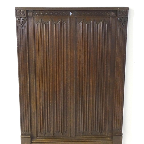 1448 - An early 20thC oak panel with carved rosettes and linen fold decoration. 33