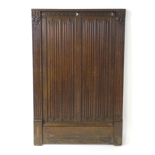 1448 - An early 20thC oak panel with carved rosettes and linen fold decoration. 33