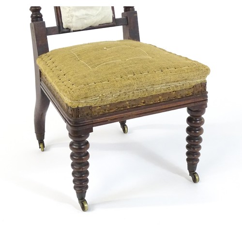 1450 - A 19thC rosewood chair with a pierced cresting rail above barley twist supports and raised on turned... 