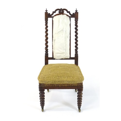 1450 - A 19thC rosewood chair with a pierced cresting rail above barley twist supports and raised on turned... 