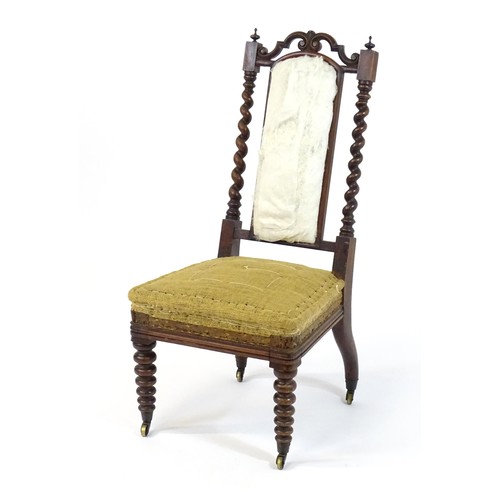 1450 - A 19thC rosewood chair with a pierced cresting rail above barley twist supports and raised on turned... 