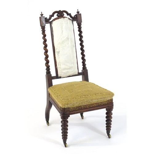 1450 - A 19thC rosewood chair with a pierced cresting rail above barley twist supports and raised on turned... 