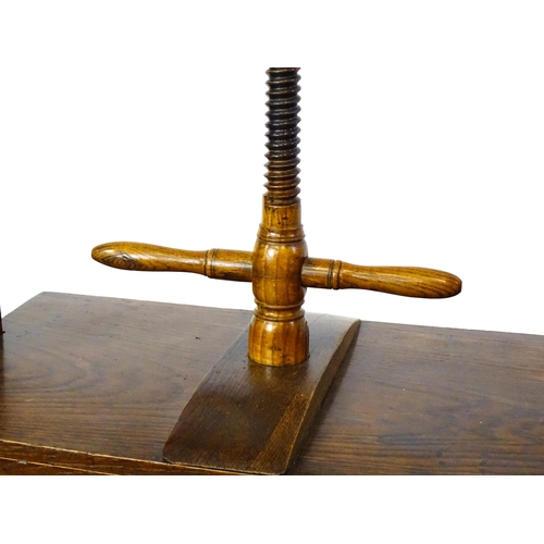 1451 - A late Georgian oak book press table, with screw system and turned handle above an adjustable press,... 