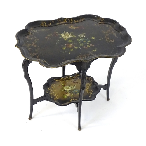 1452 - A 19thC ebonised table with two papier mache tiers, both tiers formed from tray tops and having hand... 