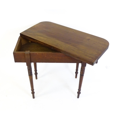 1453 - An early / mid 19thC mahogany card table, with a reeded edge above four turned tapering legs. 36