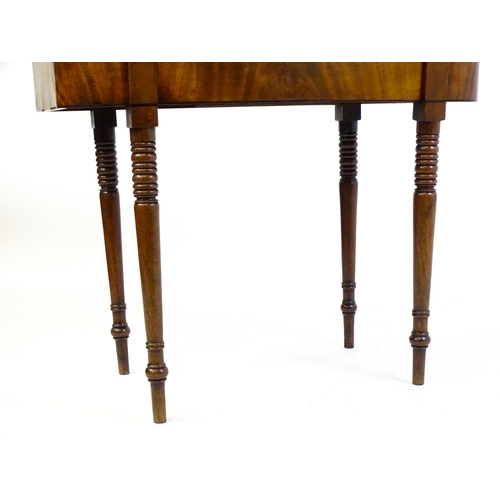 1453 - An early / mid 19thC mahogany card table, with a reeded edge above four turned tapering legs. 36