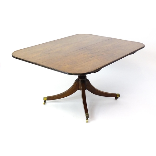 1456 - A 19thC rosewood dining table / breakfast table with a reeded tilt top above a turned pedestal and f... 